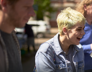 A woman in a jean jacket smiling